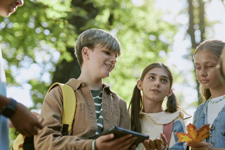 Schülerinnen und Schüler diskutieren während im Botanischen Garten über Pflanzen. Per Klick gelangen Sie zur Seite Außerunterrichtliche Veranstaltungen